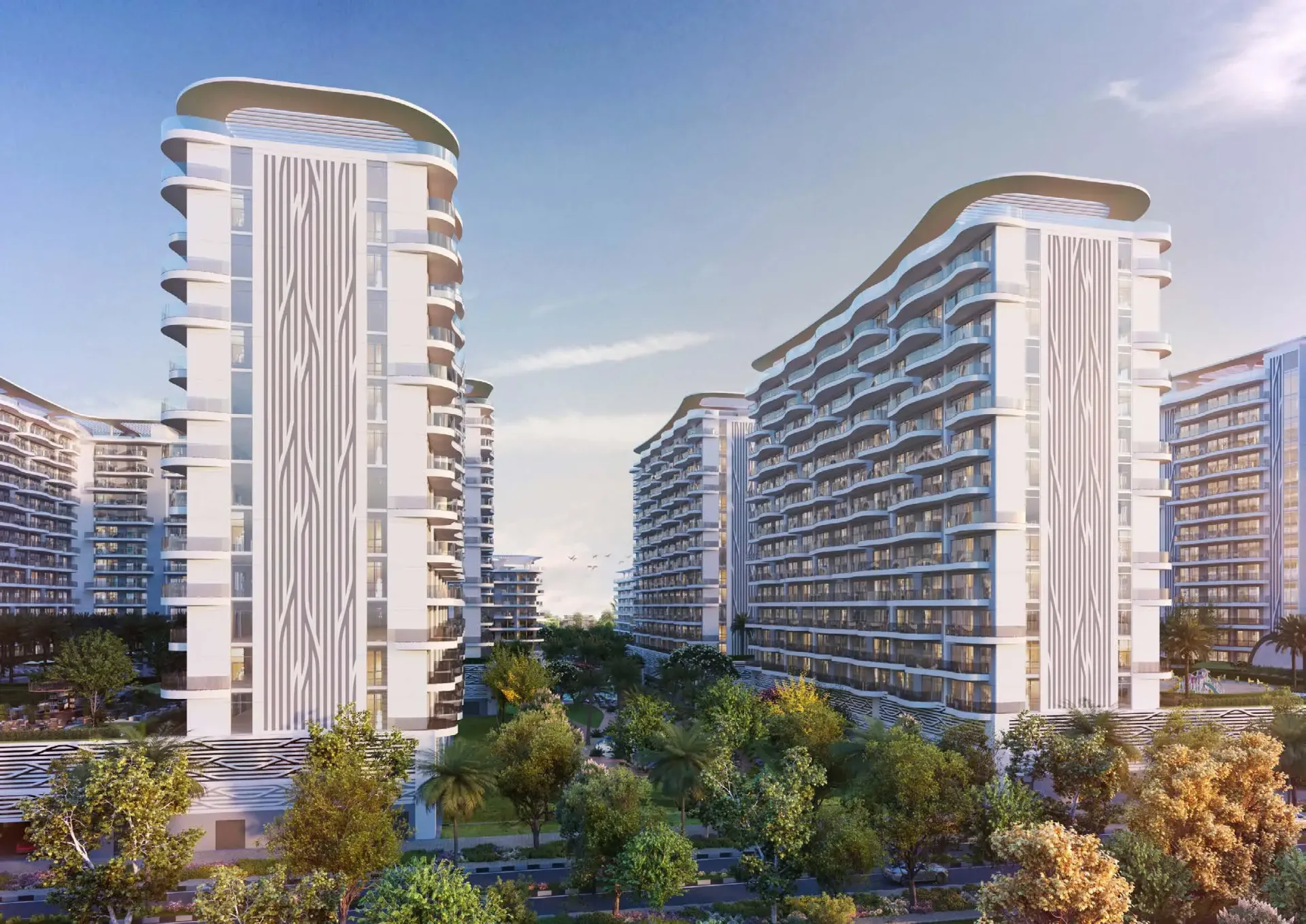 Valencia – balti gyvenamieji bokštai su banguotais balkonais tarp žaluma apaugusio kiemo